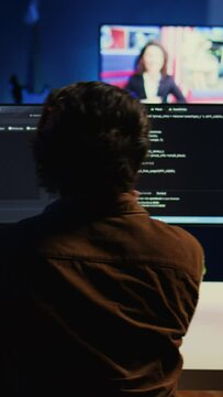 Man doing IT support job from apartment personal office drinking cup of coffee while coding. Software developer enjoying hot beverage and writing lines of code on computer, camera B