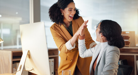 Women, business and high five for teamwork success, support and collaboration with computer in...