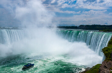 Peasure boat with tourists near Niagara Falls