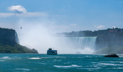 Fototapeta na wymiar Peasure boat with tourists near Niagara Falls