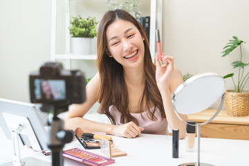 Beauty cosmetic, cute asian young woman, girl make up face by applying lip gloss, pink or nude color on her mouth in the morning at home, look natural fashion style, skin care protection of people.