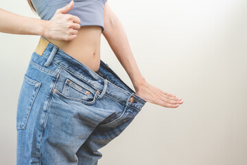 Shape slender, thin waist, attractive slim asian young woman hand show thumb and shape her weight...