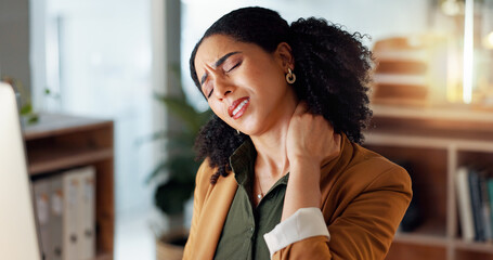 Woman, neck and hand is sore, office and ache or cramp, laptop and business or pain. Businesswoman,...