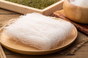 Dry Glass Noodle (Transparent bean vermicelli) on wood plate with Green beans
