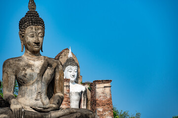 Two statues of Buddha in Wat Mahathat in Sukhothai, Thailand - 735218276
