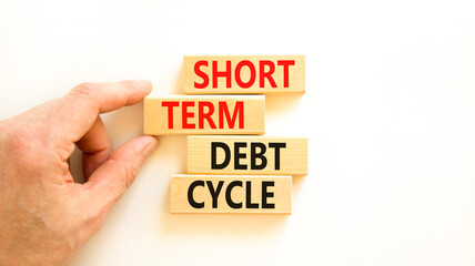 Short term debt cycle symbol. Concept words Short term debt cycle on beautiful wooden block. Beautiful white table background. Businessman hand. Business Short term debt cycle concept. Copy space.