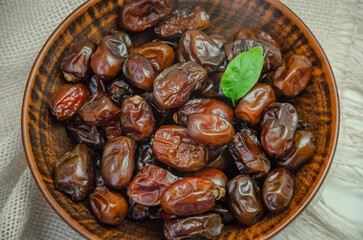Dried dates in a ceramic plate, top view