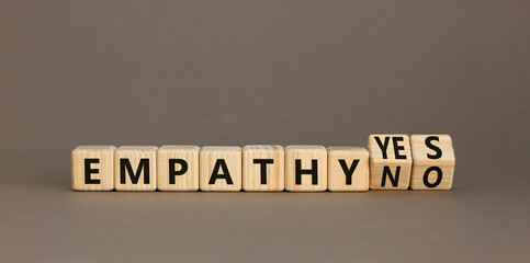 Empathy yes or no symbol. Concept words Empathy no to Empathy yes on beautiful wooden cubes. Beautiful grey table grey background. Psychological and empathy yes or no concept, copy space.