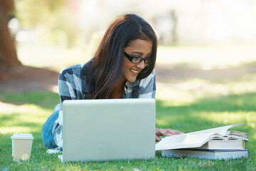 Laptop, grass or happy woman in park with books for learning knowledge, information or education. Smile, textbooks or female student in nature for studying history or typing online on college campus