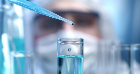 Super slow motion close up of scientist examines with pipette molecules of DNA sample substance in test tubes during biochemical analysis of experimental data research in laboratory at 1000 fps. - Powered by Adobe
