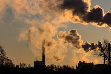 View of an industrial zone with smoking chimneys above a factory