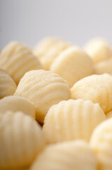 Pile of traditional fresh Raw Gnocchi on white background, Closeup, Pasta Fresca