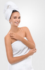 Woman, skincare and cosmetology in studio portrait, confidence and proud of shine on white background. Happy female person, towel and smile for facial treatment, glow and dermatology for grooming