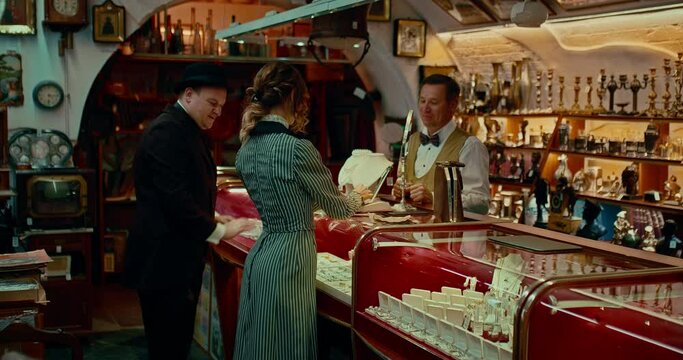 ugly man buying gift for beautiful woman in jewelry store in 19 century, 4K, Prores