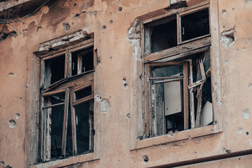 empty windows of a damaged house in Ukraine