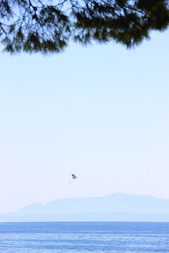 Beautiful seaside landscape and parasailing parachute in Brela, Croatia.