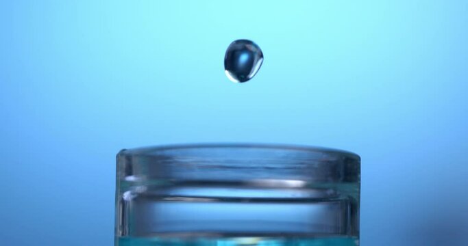 Super slow motion macro of molecules of DNA sample substance is dropping in test tubes during biochemical analysis of experimental data research by scientist in laboratory at 1000 fps.