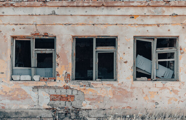 empty windows of a damaged house in Ukraine