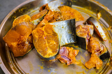 fresh fish marinating in spices at home in plat from different angle