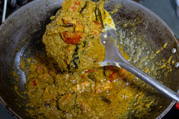 fish mixed spices cooking at cauldron at home at day