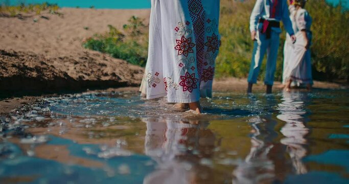 East Slavic celebration of summer solstice, closeup view of legs in river water, 4K, Prores