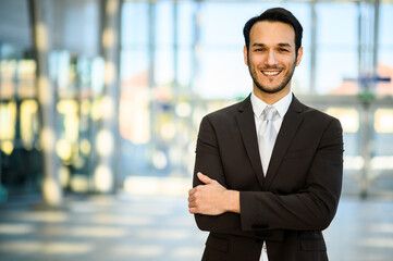Confident businessman smiling in office lobby