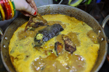 fresh cooked boiling fish gravy at cauldron at home at day