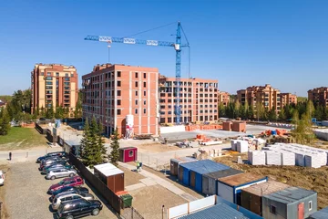 Foto op Plexiglas the construction site of an apartment building in the summer from a height © gluschenkoart