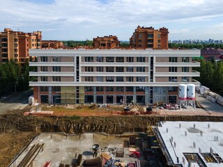 Fototapeta premium the construction site of an apartment building in the summer from a height