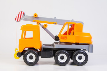 Lift truck. Multi-colored children's toys plastic trucks on a white background.