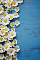 white daisies and yellow flowers on blue wooden background