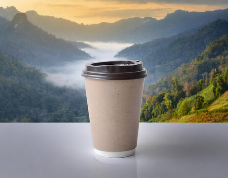 Disposable paper coffee cup on a gray background with sunlight.