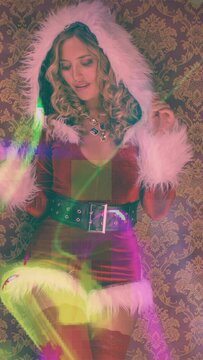 Woman in cute santa claus costume for disco shoot in vertical