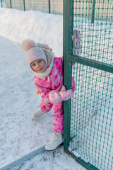 Happy girl skating on the ice rink evening at sunset