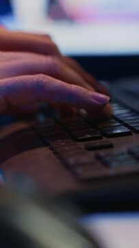 Focus on computer peripheral used by IT admin to type lines of code on desktop PC in apartment. Close up shot of keyboard used by software engineer programming at home, camera A