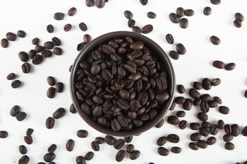coffee beans in a bowl on a white background