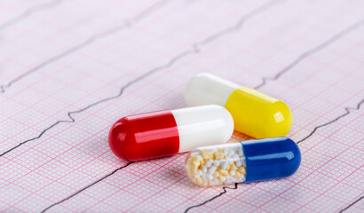 medical pills on the background of a medical cardiogram