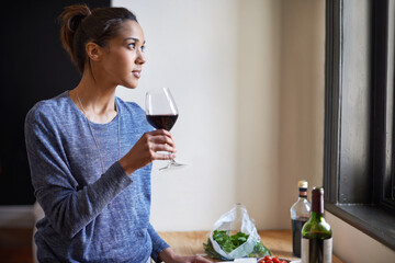 Woman, red wine and thinking in kitchen, reflection and future, drink and food for cooking at home. Relax with alcohol in glass, inspiration or insight with memory, enjoy and wellness with beverage
