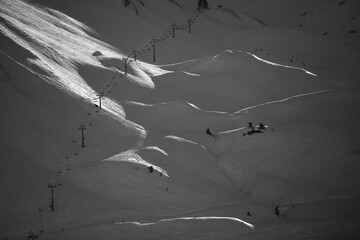 black and white picture of a ski lift in the swiss alps