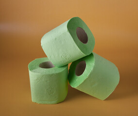 green toilet paper on an orange background