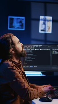 Software engineer doing programming using augmented reality visualization during remote job shift in home office. IT admin working on computer, looking at AR hologram, camera B