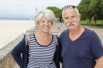 senior couple relaxing by the sea