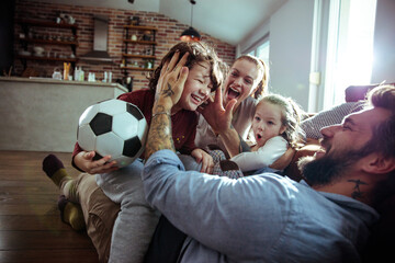 Happy young family playing together at home