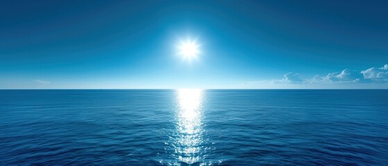 a large body of water with a bright sun in the middle of the middle of the ocean on a sunny day.