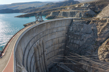 Aerial view of a concrete dam in the mountains.