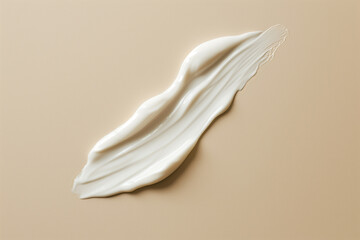 A smear of lotion on a beige background