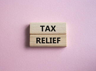 Tax Relief symbol. Concept word Tax Relief on wooden blocks. Beautiful pink background. Business and Tax Relief concept. Copy space