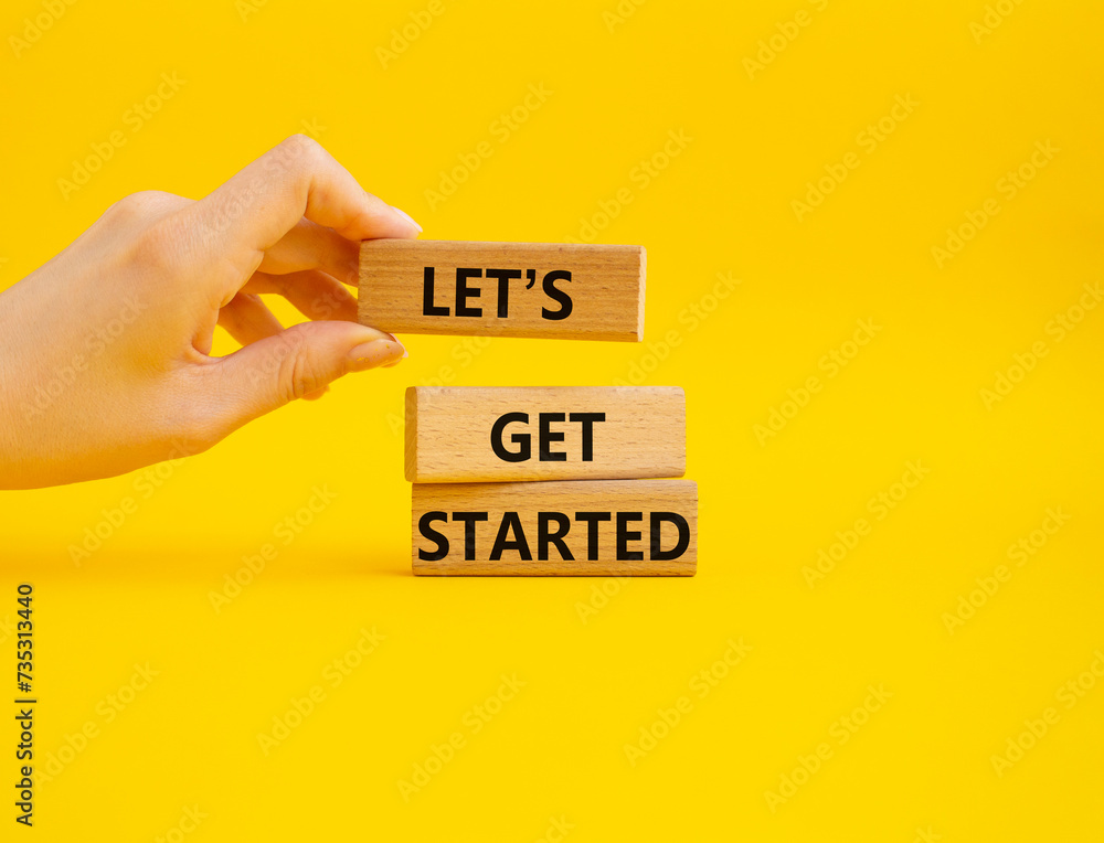 Canvas Prints lets get started symbol. concept words lets get started on wooden blocks. beautiful yellow backgroun