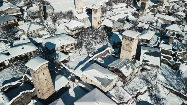 Flying through the streets of an ancient village in the Caucasus Mountains in winter