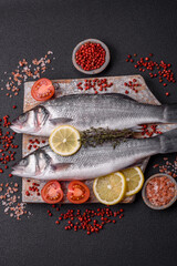 Fresh raw ocean sea bass fish with salt, spices and herbs